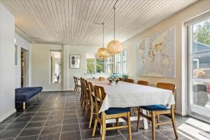 a dining room with a table and chairs at 40117-juelsminde-Gludvej-7 in Juelsminde +51 photos