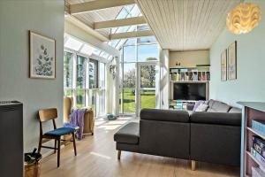 a living room with a couch and a table at 40117-juelsminde-Gludvej-7 in Juelsminde