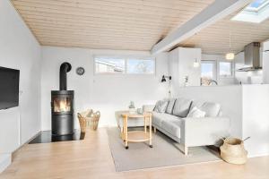 a living room with a couch and a fireplace at 30461-Odder-Hulager-6 in Odder