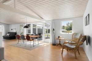a dining room and living room with a table and chairs at 30461-Odder-Hulager-6 in Odder +39 photos