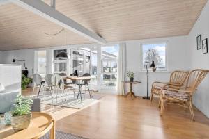 a living room with a table and chairs at 30461-Odder-Hulager-6 in Odder