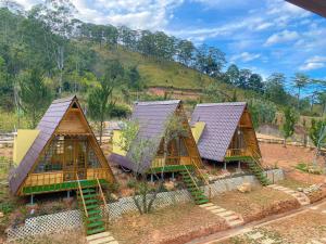 a group of four houses with their roofs at Đồi Lát Homestay in Da Lat