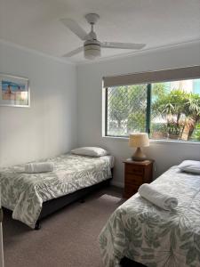 a bedroom with two beds and a window at Bayview Harbourview Apartments in Mooloolaba +81 photos