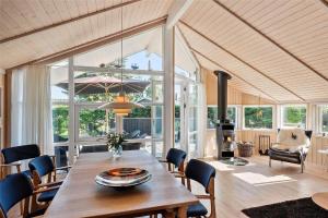 a dining room with a table and chairs at 40146-Juelsminde-Elmealle-24 in Juelsminde