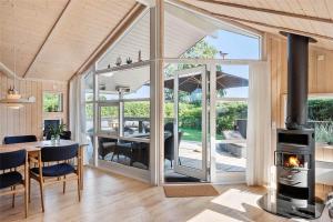 a living room with a table and a fireplace at 40146-Juelsminde-Elmealle-24 in Juelsminde +21 photos