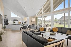 a large living room with couches and a table at 30484-Odder-Strandvaenget-60 in Odder