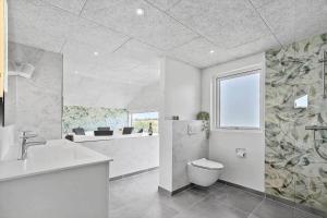 a bathroom with a toilet and a sink at 30484-Odder-Strandvaenget-60 in Odder +39 photos