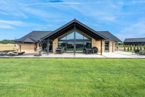 a house with a large glass window and a yard at 30484-Odder-Strandvaenget-60 in Odder