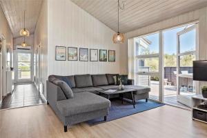 a living room with a couch and a table at 40501-Juelsminde-Pot-Strandby-251 in Sønderby