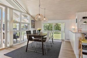 a dining room with a table and chairs at 40501-Juelsminde-Pot-Strandby-251 in Sønderby