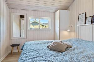 a bedroom with a large bed with a window at 40501-Juelsminde-Pot-Strandby-251 in Sønderby +28 photos