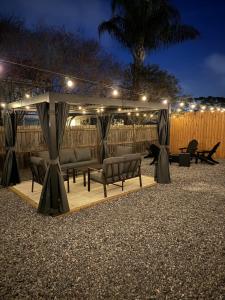 a gazebo with a table and chairs under it at night at Sunset Beachside Getaway, 6 mins WALK to the Beach in Panama City Beach