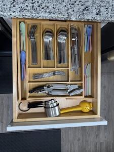 a wooden cabinet filled with kitchen utensils at Sunset Beachside Getaway, 6 mins WALK to the Beach in Panama City Beach