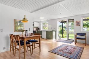 a kitchen and dining room with a table and chairs at 30609-Odder-Spovevej-1 in Odder +21 photos