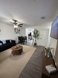 a living room with a couch and a table at Sunset Beachside Getaway, 6 mins WALK to the Beach in Panama City Beach