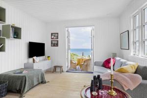 a living room with a couch and a view of the ocean at 30553-Odder-Toldvejen-45-F in Odder