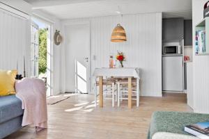 a living room with a table and a kitchen at 30553-Odder-Toldvejen-45-F in Odder +21 photos