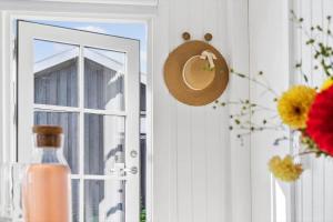 a door with a window and a hat and flowers at 30553-Odder-Toldvejen-45-F in Odder