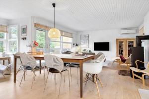 a living room with a dining room table and chairs at 40162-Juelsminde-Gludvej-9 in Juelsminde