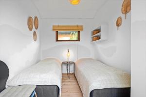 two beds in a room with white walls at 30401-Odder-Stakket-Torn-12 in Odder