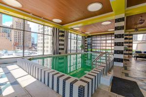 an indoor swimming pool in a building with windows at Stylish 1 Bed In Downtown Cincinnati in Cincinnati