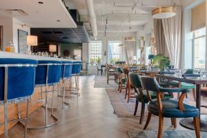 a bar in a restaurant with blue bar stools at Stylish 1 Bed In Downtown Cincinnati in Cincinnati