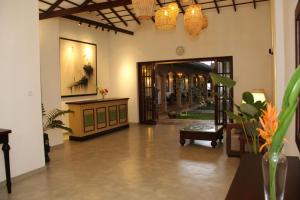 a lobby with a hallway with doors and plants at Villa AyuSri in Ambalangoda