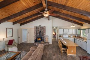 a living room with a couch and a fireplace at Maple Leaf Lodge by NW Comfy Cabins in Leavenworth