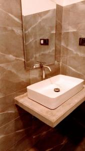 a bathroom with a white sink and a mirror at Ahangama Wave Nook in Ahangama