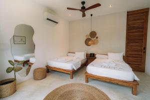 a bedroom with two beds and a ceiling at Terra Resort in Ahangama +66 photos