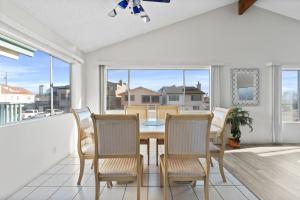 a dining room with a table and chairs on a balcony at Ocean View Beach Stay w Pool Table & Bikes in Oxnard