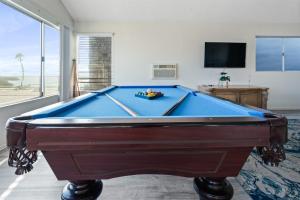 a blue pool table in a living room with a tv at Ocean View Beach Stay w Pool Table & Bikes in Oxnard