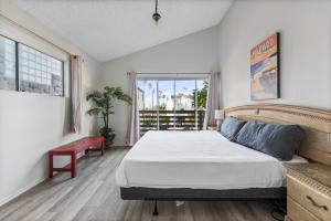 a bedroom with a large bed and a window at Ocean View Beach Stay w Pool Table & Bikes in Oxnard +11 photos