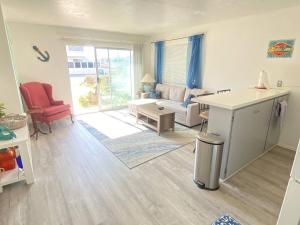 a living room with a couch and a table at Sea View, Boards, Bikes, Wd in Oxnard