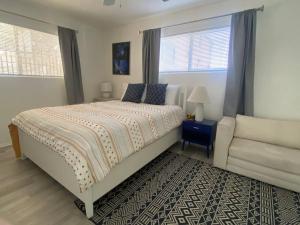 a bedroom with a bed and a couch and a window at Sea View, Boards, Bikes, Wd in Oxnard +8 photos