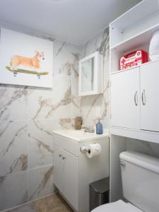 a bathroom with a toilet and a marble wall at Private 1BR w Yard & King Bed Simi Valley in Simi Valley