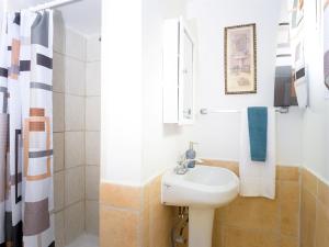 a white bathroom with a sink and a shower at Private 1BR w Yard & King Bed Simi Valley in Simi Valley +4 photos