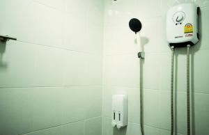 a shower in a bathroom with a hair dryer at Early Bird Hostel Ayutthaya in Phra Nakhon Si Ayutthaya