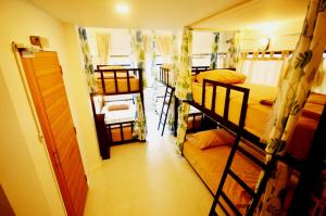 a room with three bunk beds and a hallway at Early Bird Hostel Ayutthaya in Phra Nakhon Si Ayutthaya
