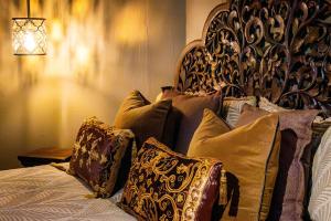 a bed with pillows on it in a room at Edwoods Boutique Bed & Breakfast in Oamaru