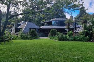 a house with solar panels on top of a yard at Edwoods Boutique Bed & Breakfast in Oamaru