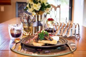 a plate of food on a wooden table at Edwoods Boutique Bed & Breakfast in Oamaru