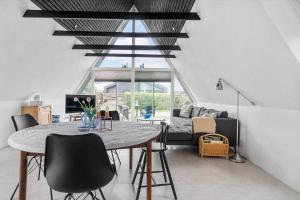 a living room with a table and a couch at 40160-Juelsminde-Hasselvej-8 in Juelsminde