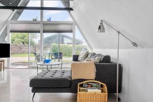 a living room with a couch and a table at 40160-Juelsminde-Hasselvej-8 in Juelsminde