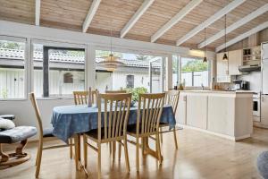a kitchen and dining room with a table and chairs at 30536-Odder-Strandagervej-3 in Odder
