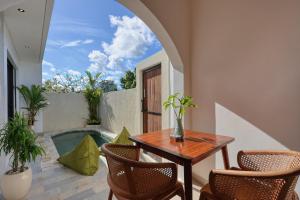 a patio with a table and chairs and a swimming pool at Asaka Private Villa in Nusa Penida