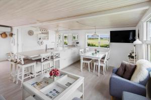 a kitchen and living room with a table and chairs at 40606-Juelsminde-Pilevaenget-24 in Juelsminde