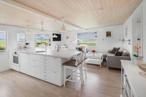 a kitchen and living room with a table and a couch at 40606-Juelsminde-Pilevaenget-24 in Juelsminde