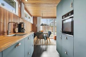 a kitchen with a sink and a dining room at 30325-Odder-Rythiavang-22 in Odder