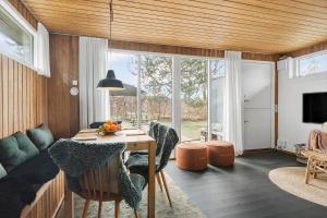 a living room with a table and chairs and a couch at 30325-Odder-Rythiavang-22 in Odder